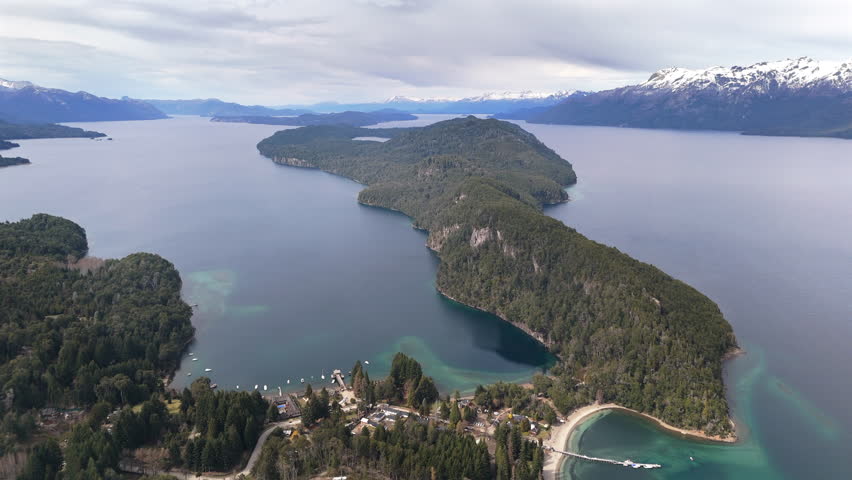 Serene aerial drone footage gliding over the lush forests and tranquil beauty of Parque Nacional Arrayanes, capturing stunning natural landscapes in Patagonia, Argentina.