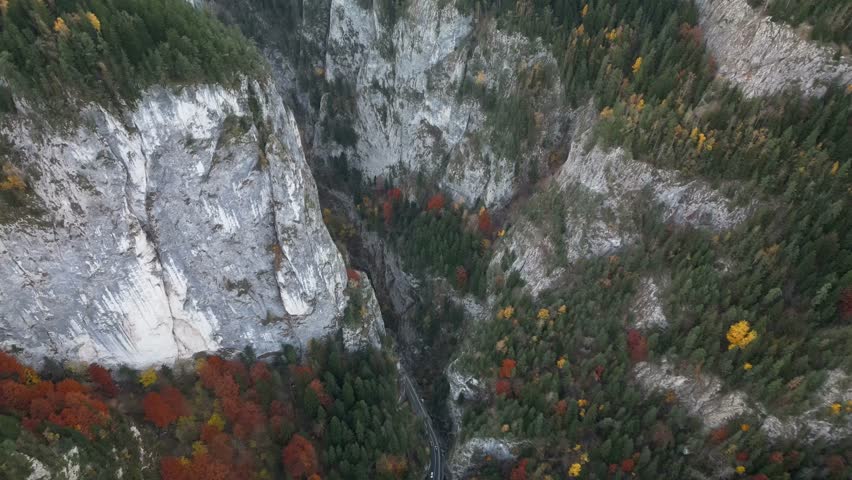 Amazing aerial drone overview of the mountain pass and steep canyon walls of the Bicaz Gorges during the colorful autumn season