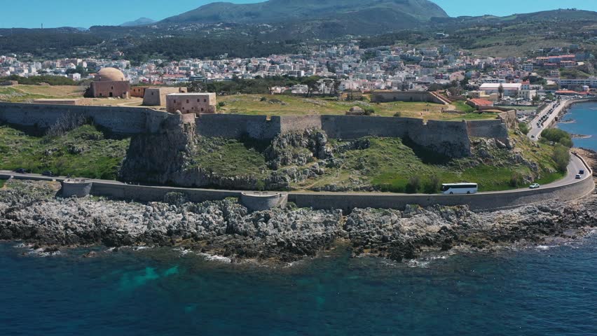 A coach traveling along scenic roads in Crete, surrounded by hills and Mediterranean charm, symbolizing adventure and exploration