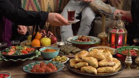 Muslim family gathered around a table during Ramadan, sharing a joyful Iftar meal with traditional dishes and dates, symbolizing togetherness, faith, and celebration of the holy month - Powered by Shutterstock - Get 15% off with code: PIKWIZARD15