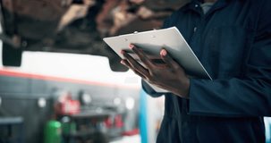 Mechanic, thinking and checklist with car repair shop, calibration or maintenance garage. Vehicle, black repairman and service clipboard with inspection for quote, quality control or fixing workshop - Powered by Shutterstock - Get 15% off with code: PIKWIZARD15