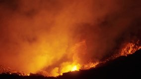 A dramatic scene of a wildfire in Malibu, Los Angeles, January 7, 8, 9, 2025, with helicopters battling the flames captured, showcasing the urgency and scale of the disaster. - Powered by Shutterstock - Get 15% off with code: PIKWIZARD15