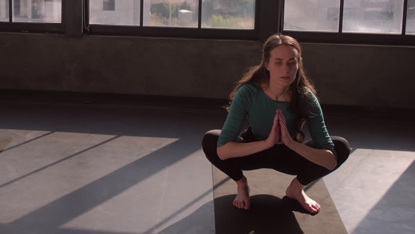 Active group. Stretch training. Sport recreation. Female instructor practice gymnastic workout balance exercise with people in activewear on fitness mat gym studio indoors.