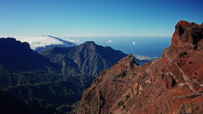 Aerial drone shot over the National park of Caldera de Taburiente in La Palma, Canary Islands, Spain. High view of the Rugged mountains, picturesque landscape and the coastline in the background.