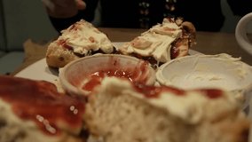 A plate of scones topped with clotted cream and jam, evoking comfort and indulgence - Powered by Shutterstock - Get 15% off with code: PIKWIZARD15