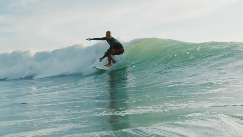 Surfer rides the wave in Brazil and passes by the camera