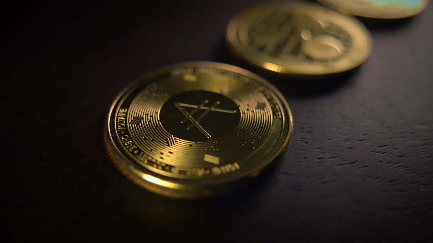 Glistening Cryptocurrency Coins Displayed on a Dark Surface for Enhanced Visual Impact