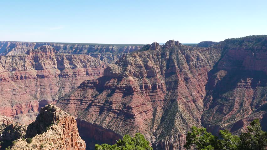Witness stunning red rock formations and vast chasms as visitors marvel at the Grand Canyon