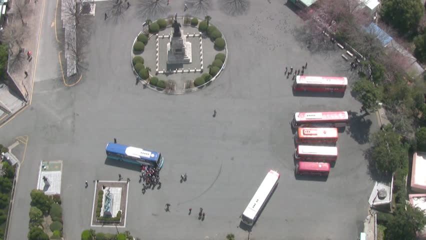 Sunny day. On the square in front of the monument a few coaches and a lot of