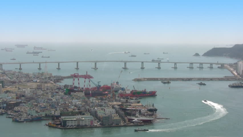 Hot sunny day. Top view of a portion of the port of Pusan. Busy traffic of small