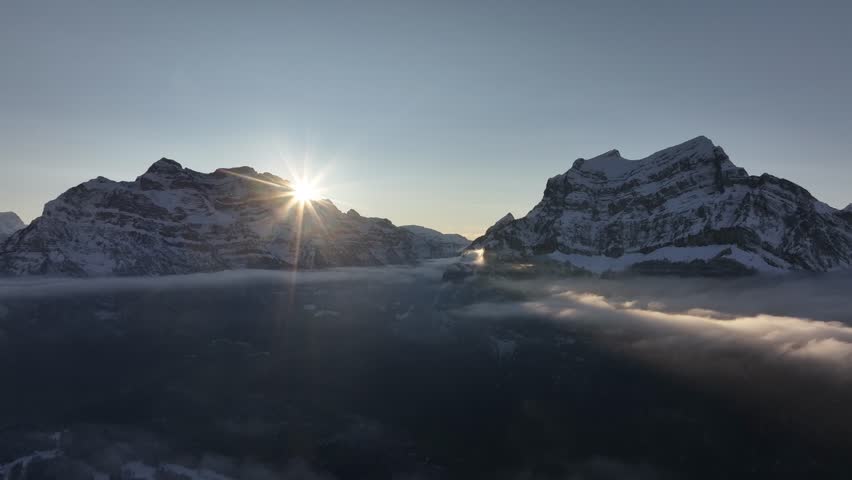 Sunrise over snowy peaks Rautispitz and Glärnisch, Glarus Nord, Switzerland, serene beauty