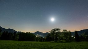 Star in Starry night sky moving over countryside nature at full moon Astronomy time lapse Night to day - Powered by Shutterstock - Get 15% off with code: PIKWIZARD15