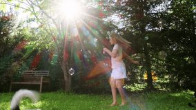 A young girl uses a bubble wand to blow soap bubbles in a sunny backyard, while her playful dog runs through the scene, with bright sunlight filtering through the trees and adding a magical glow - Powered by Shutterstock - Get 15% off with code: PIKWIZARD15