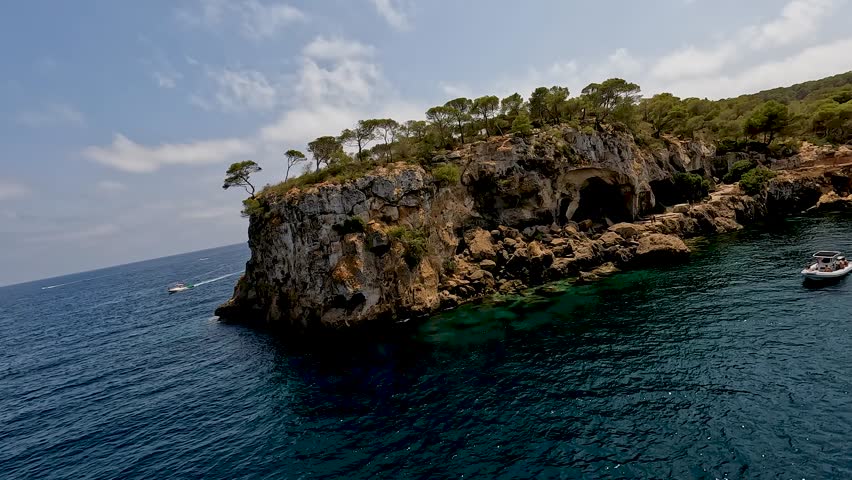 Rocky portals vells coast in mallorca with caves, trees, and turquoise water, aerial view