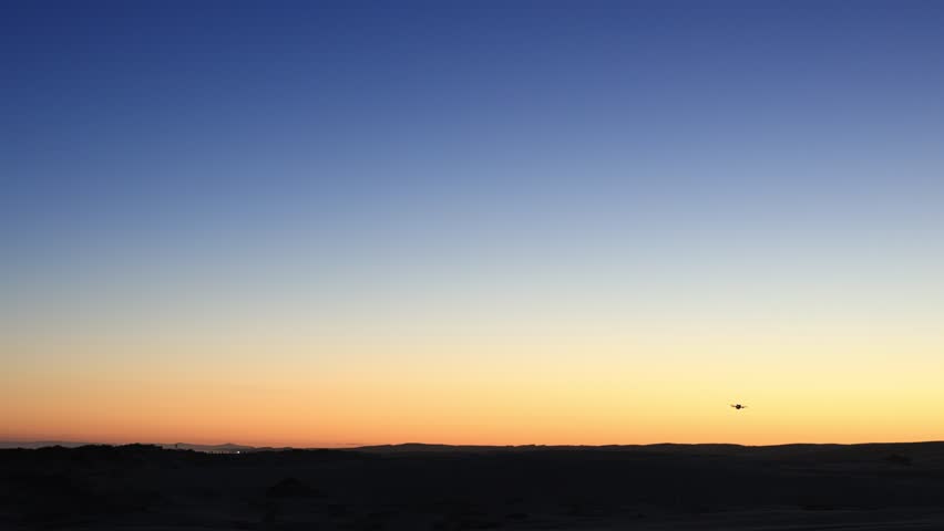 Drone flying in the sunset