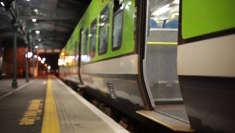 Passengers enter intercity train at Athenry station at night