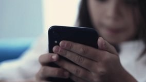 Kid Focused on Smartphone, Close-Up of Hands Holding Cellphone and Browsing Social Media - Powered by Shutterstock - Get 15% off with code: PIKWIZARD15