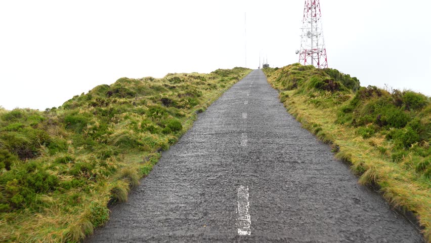Road leading up to scenic view point of the Lagoa do fogo, crater lake on the Azores island, Portugal, misty view point, hiking routes.