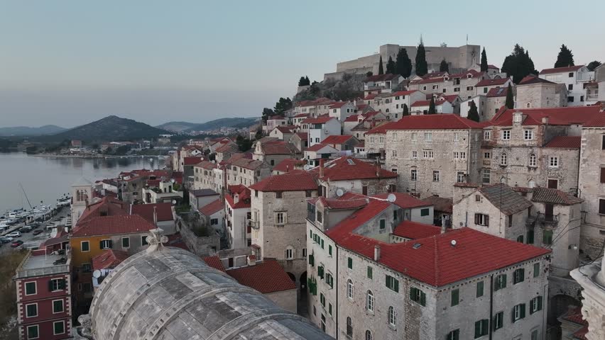 Close-up drone footage of the Cathedral of St. James in Sibenik, Croatia, focusing on its intricate carvings, stone details, and historical significance as a masterpiece of Renaissance architecture.