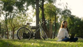Beautiful young asian woman working with laptop and listening music with smartphone in peacefulness time at spring nature park. Happy moment of student woman in university summer. - Powered by Shutterstock - Get 15% off with code: PIKWIZARD15