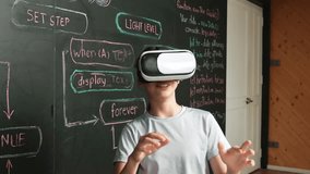 Girl wear VR glass while mentor pointing at blackboard and explain engineering code. African student writing system while receive advice from teacher at table with electronic equipment. Edification - Powered by Shutterstock - Get 15% off with code: PIKWIZARD15