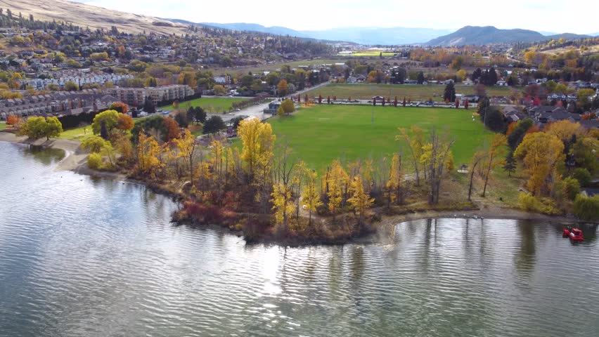 LakeFront Reflections, Fall Season Autumn Colours. Colourful Fall Leaves on Trees in Nature. Wood Lake, Lakecountry, BC, Okanagan Valley, British Columbia, Canada. Wide Landscape Beasley Park