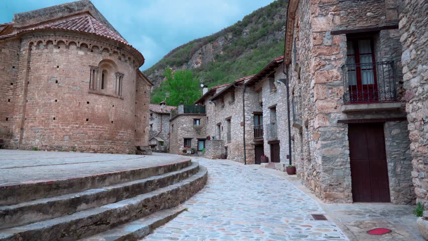 Landscape of a medieval village in the Pyrenees with mountains in the background and camera movement. From Beget, Girona, Catalonia, Spain, Europe.