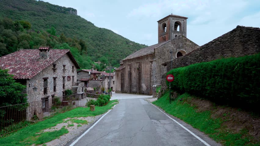 Landscape of a medieval village in the Pyrenees with mountains in the background and camera movement. From Beget, Girona, Catalonia, Spain, Europe.