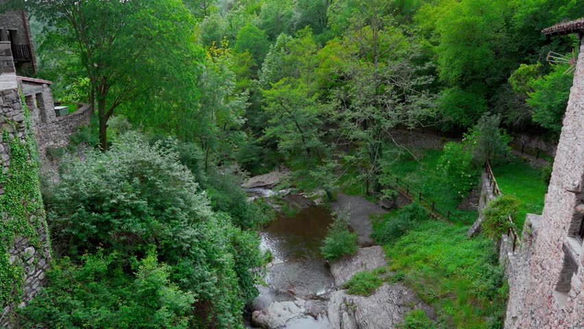 Landscape of a medieval village in the Pyrenees with mountains in the background and camera movement. From Beget, Girona, Catalonia, Spain, Europe.