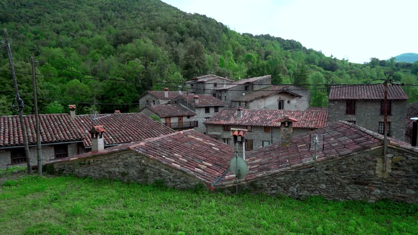 Landscape of a medieval village in the Pyrenees with mountains in the background and camera movement. From Beget, Girona, Catalonia, Spain, Europe.