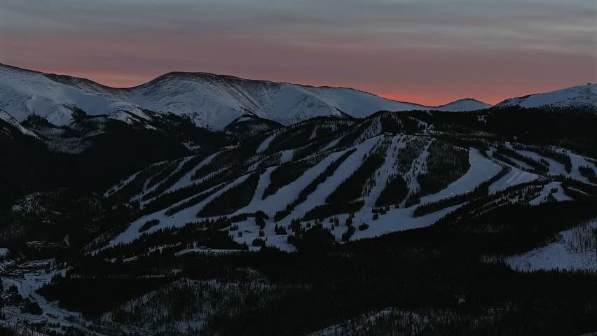 December Winter Solstice vibrant orange pink sunset sunrise Winter Park Resort Mary Jane Ski snowboard run trails Bertoud Pass Rocky Mountains Fraser Colorado snowcats grooming ski lifts circle left