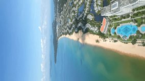 Vertical video. Aerial view of the coastline of tourist resorts on the tropical island of Phu Quoc in Vietnam. - Powered by Shutterstock - Get 15% off with code: PIKWIZARD15