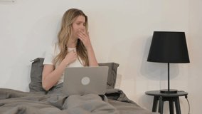 Sick Young Woman Coughing while Using Laptop in Bed - Powered by Shutterstock - Get 15% off with code: PIKWIZARD15