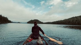 a woman paddling on temagami on a beautiful day, the CANOE GLIDES THROUGH THE LAKE - Powered by Shutterstock - Get 15% off with code: PIKWIZARD15