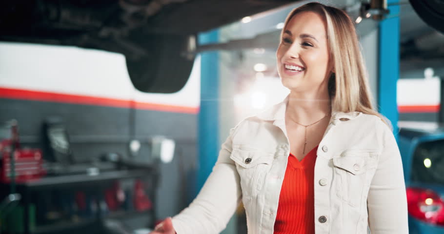 Mechanic, woman and handshake for car repair shop, calibration or maintenance garage. Greeting, repairman and service welcome with inspection for quote, quality control or auto engineer workshop