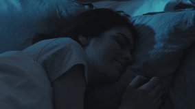 Night rest. Peaceful sleep. Relaxed calm happy woman enjoying dreaming on soft comfortable soft pillow in bed in dark home bedroom. - Powered by Shutterstock - Get 15% off with code: PIKWIZARD15