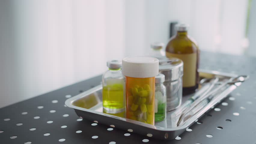 Cropped shot of hands of unrecognizable person choosing painkillers from tray with medication while being sick