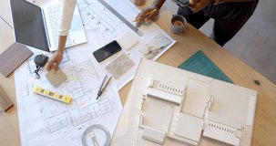 Working on architectural plans, person using tablet and pencil at desk. Architecture, planning, design, drafting, workspace, creative - Powered by Shutterstock - Get 15% off with code: PIKWIZARD15