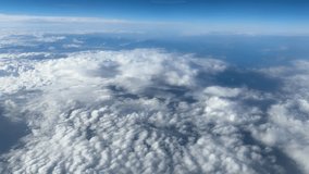 Cumulus clouds from above against the background of the ground, view from an airplane window during a flight at high altitude
 - Powered by Shutterstock - Get 15% off with code: PIKWIZARD15