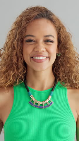 Face, pointing to you and woman in studio, smile and expression on gray background. Portrait, winner and happy person with hand gesture, opportunity and sign with support, motivation and decision