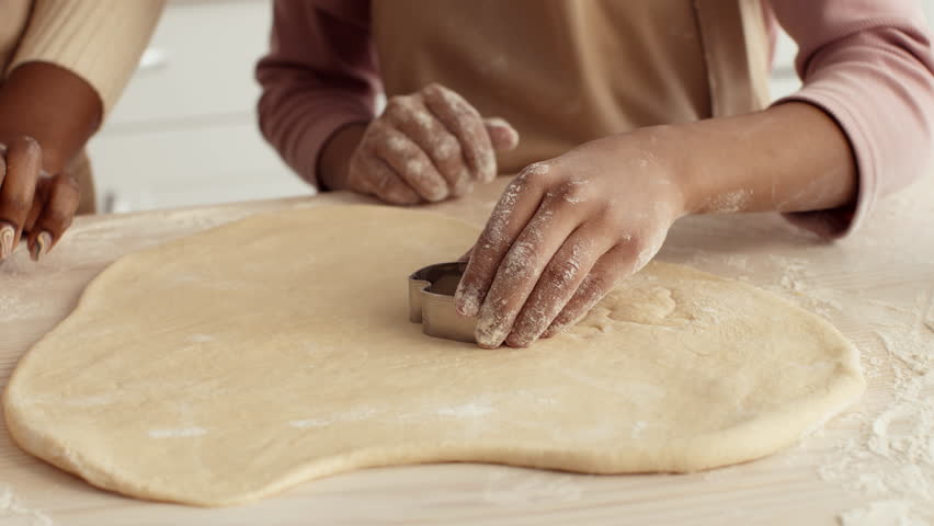 A mother and daughter are joyfully baking in their kitchen. They are working together to roll out dough, creating delicious pastries while sharing special moments and laughter. - Powered by Shutterstock - Get 15% off with code: PIKWIZARD15