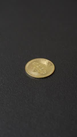 Bitcoin as a metal round coin on a dark background. Cryptocurrency, blockchain crypto exchange