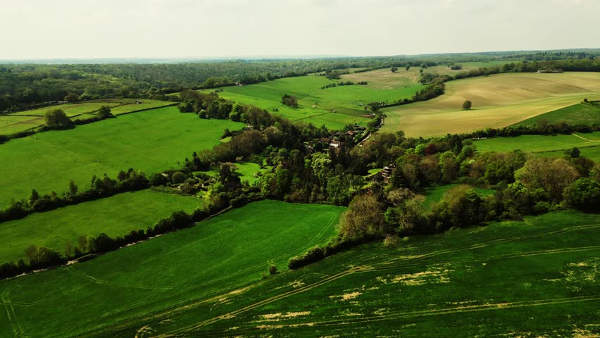 An aerial footage of vast green fields in a small rural village near Hemel Hempstead town in the Dacorum district in Hertfordshire, England, UK