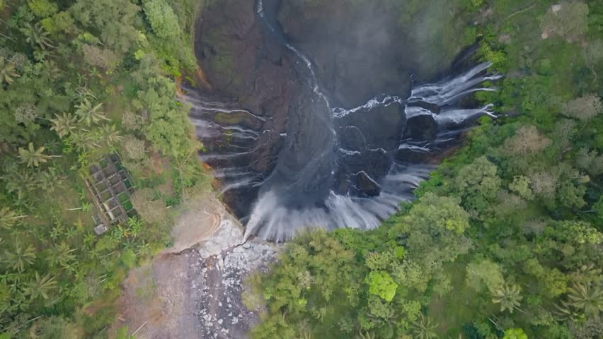 Aerial view of majestic Tumpak Sewu waterfalls in slow motion, Java, Indonesia