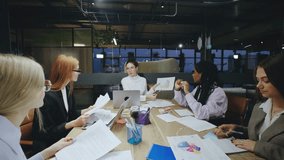 A group of business women meeting is taking place in a modern office space that features various diverse professionals, all engaging in productive discussions while using technology - Powered by Shutterstock - Get 15% off with code: PIKWIZARD15