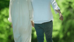 Couple walking in fresh greenery - Powered by Shutterstock - Get 15% off with code: PIKWIZARD15