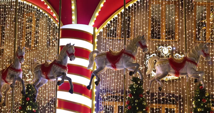 Closeup of a glowing carousel with ornate wooden horses. A magical amusement ride capturing timeless fun and artistry. 