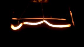 Close-up of a light bulb filament flashing on and off - Powered by Shutterstock - Get 15% off with code: PIKWIZARD15