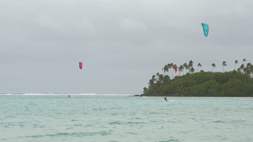 Kite surfers enjoying a windy day at Tropical Beach, Rarotonga, Cook Islands