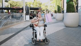 Happy disabled woman showing shopping bags in electric wheelchair - Powered by Shutterstock - Get 15% off with code: PIKWIZARD15